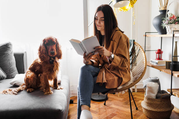 istock Weekend relaxation with good book and pet dog. 1366649474