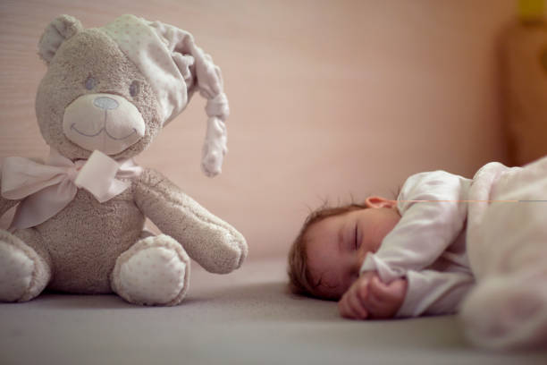 istock teddy bear.Cute baby  is peaceful sleeping 1366649505