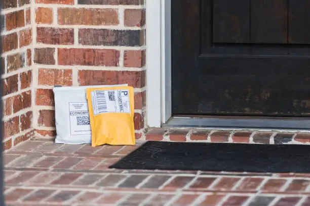 Two packages that were dropped off near the front door of the home are left unprotected.