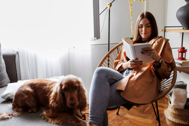 istock Weekend relaxation with good book and pet dog. 1366649898