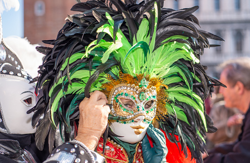 Street actors with mask in the Venice Carnival, street photography, just before Covid strikes Europe in 2020