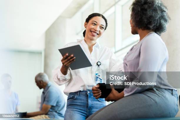 Physical Therapist Prepares To Work With Patient Stock Photo - Download Image Now - Doctor, Patient, Discussion