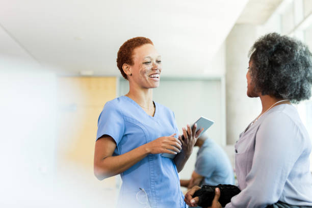 Caring female physical therapist talking with patient