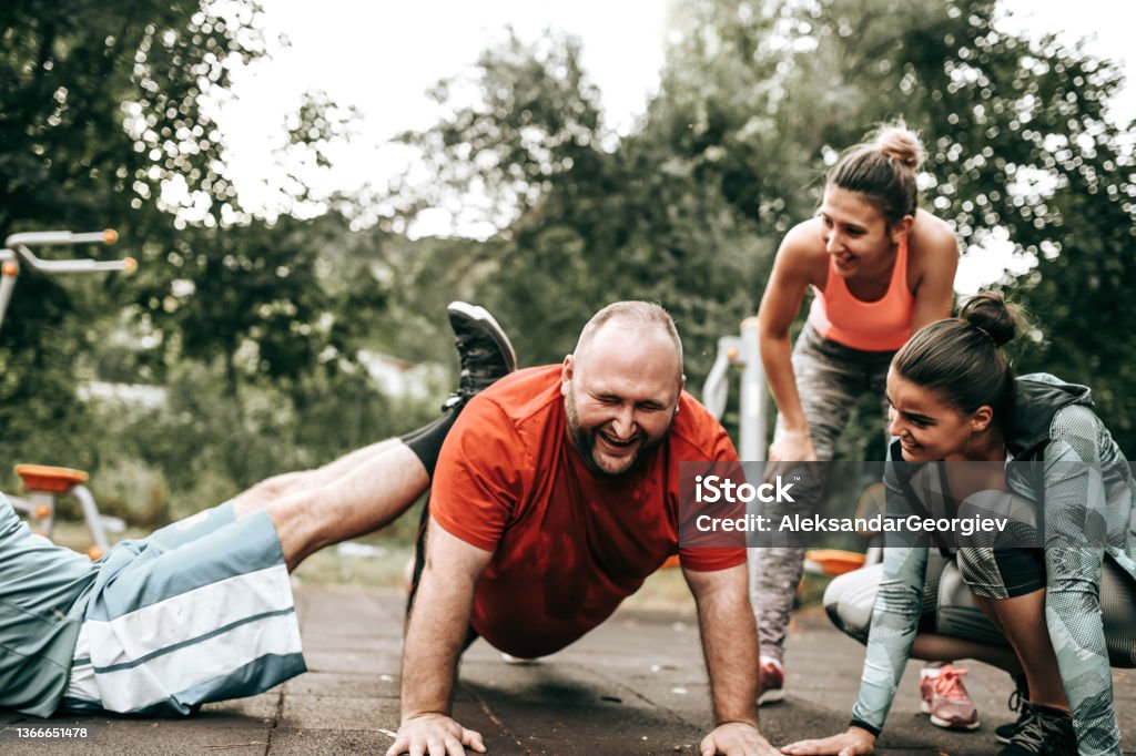 Overweight Male Getting Getting Motivated By Friends To Perform Better During Workouts Athlete Stock Photo