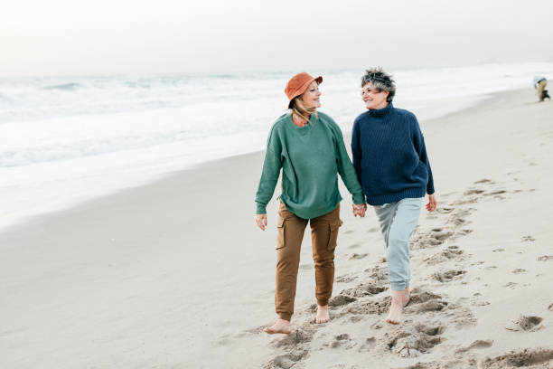 istock Senior women walking on the beach 1366652817