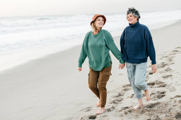 istock Senior women walking on the beach 1366652832