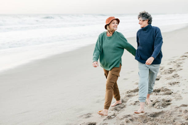 istock Senior women walking on the beach 1366652839