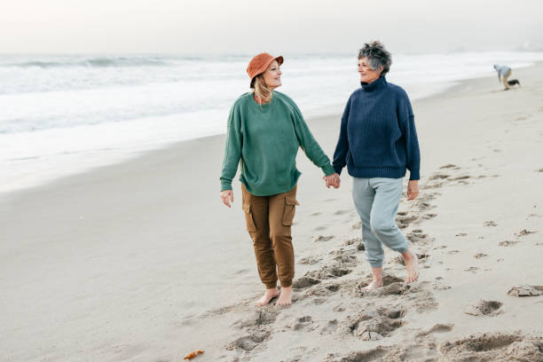 istock Senior women walking on the beach 1366652851