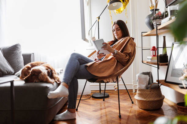 istock Weekend relaxation with good book and pet dog. 1366654331