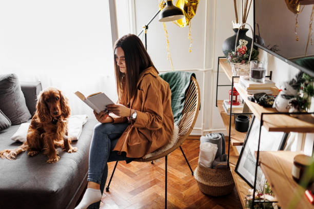istock Weekend relaxation with good book and pet dog. 1366654571