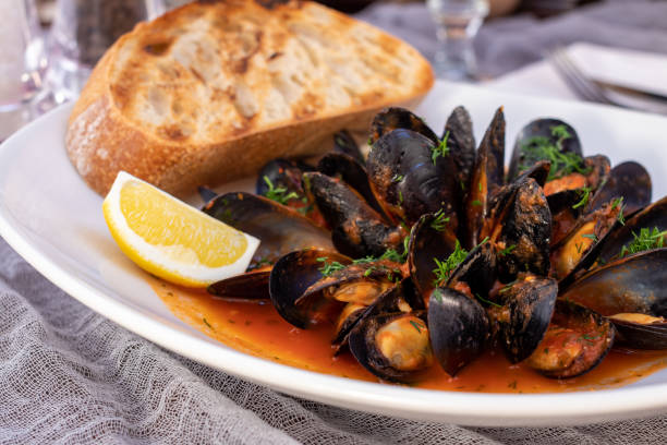 istock Mussels in tomato sauce with lemon and grilled bread 1366654636