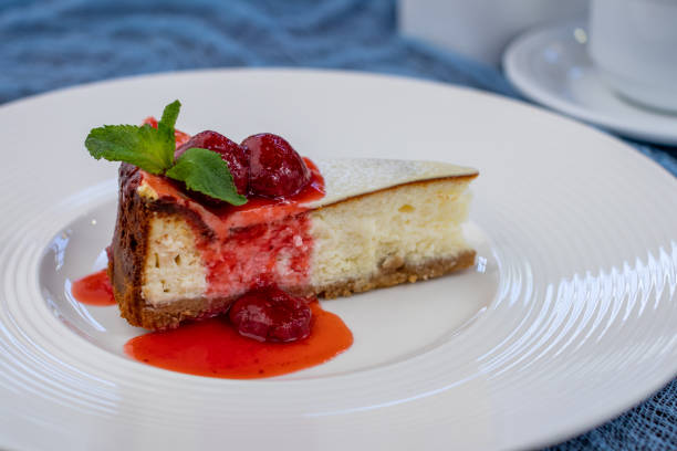 istock Classic cheesecake with strawberry and mint on white plate 1366655391