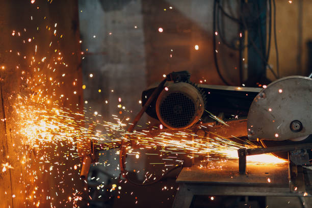 istock Metal processing with compound mitre saw with circular disk blade. Sparks in metalworking at factory. 1366655415