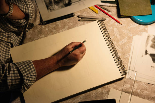 istock Zenith shot of a man's hand holding a pencil while making a drawing. Old people activities concept. 1366655743