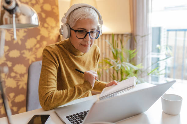 istock Senior woman working on laptop at home 1366657161