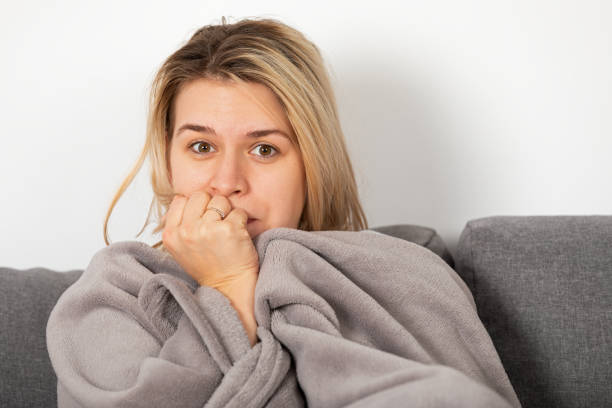 istock Sick woman lying on the couch 1366657940