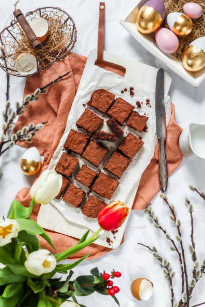 istock Homemade chocolate chip brownies baking for easter spring time with tulips and Easter eggs 1366659472