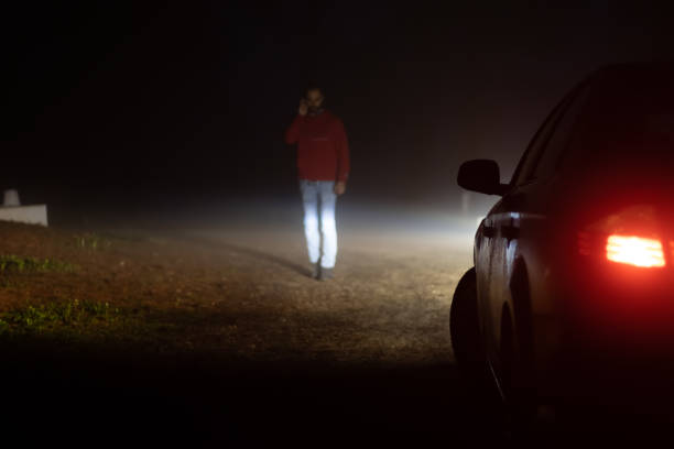 istock Man calling insurance company outside his broken down car 1366659678