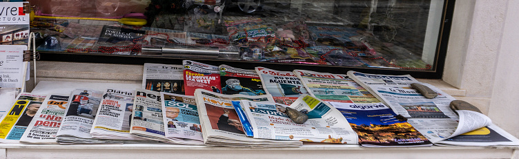 A selection of international newspapers for sale outside a shop in Loule, Portugal.