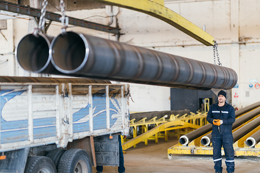 Unloading steel products and tubes with crane in factory
