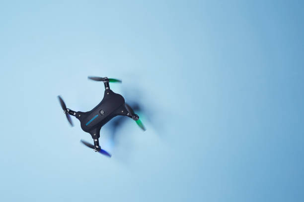 istock Drone flying above the bright solid blue fond background 1366664386
