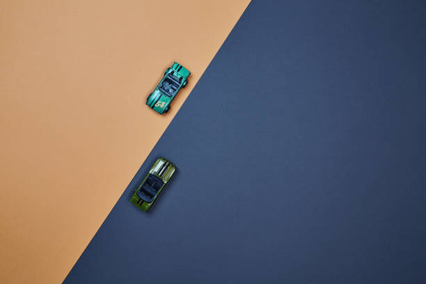 istock Two micro toy small mini cars opposite direction top view 1366664470