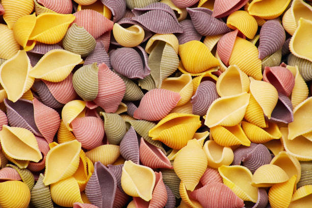 istock Colored traditional raw uncooked italian conchiglie pasta 1366666723