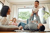 Shot of a young family playing together on the lounge floor at home