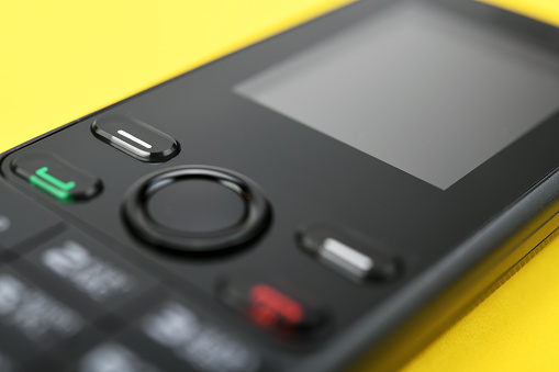Retro mobile phone on a yellow background.