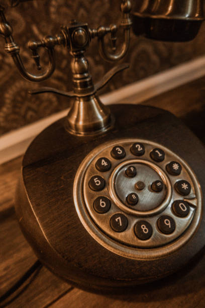 istock Old Wood panel Rotary Phone with brass details on Dark Wood table 1366669593