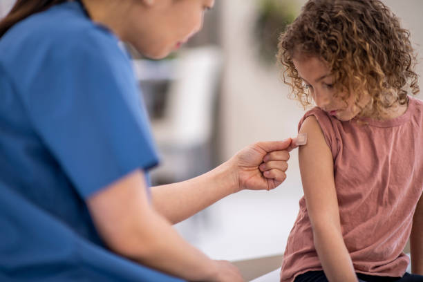 istock Pediatrician Applying a Bandage 1366670960