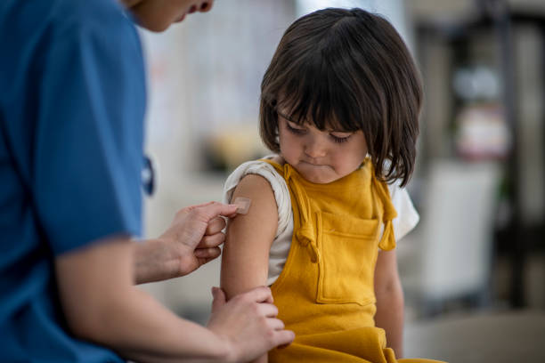 istock Doctor Putting a Bandage on a Young Girl 1366671004
