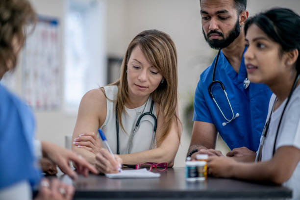 istock Medical Students In A Meeting Together 1366671011