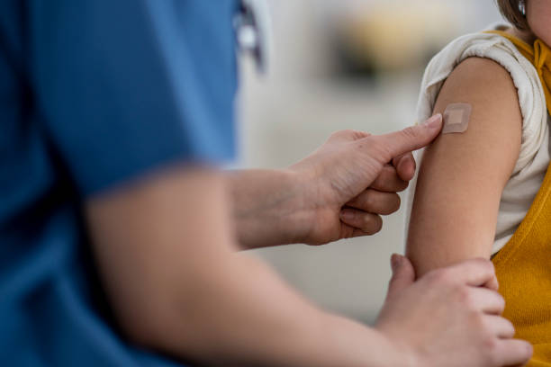 istock Doctor Putting a Bandage on a Young Girl 1366671012