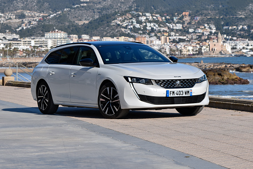 Sitges, Spain - 5th February, 2020: Peugeot 508 SW Hybrid stopped on a street. This model is the largest vehicle in Peugeot offer in Europe.