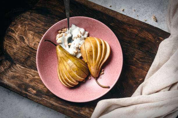 Pear and yogurt with muesli on plate Flat lay of Pear and yogurt with muesli on plate food styling stock pictures, royalty-free photos & images