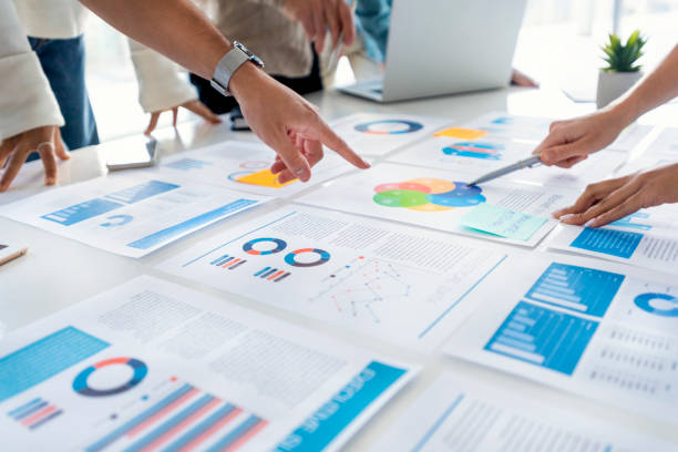 istock Paperwork and hands on a board room table at a business presentation or seminar 1366672570
