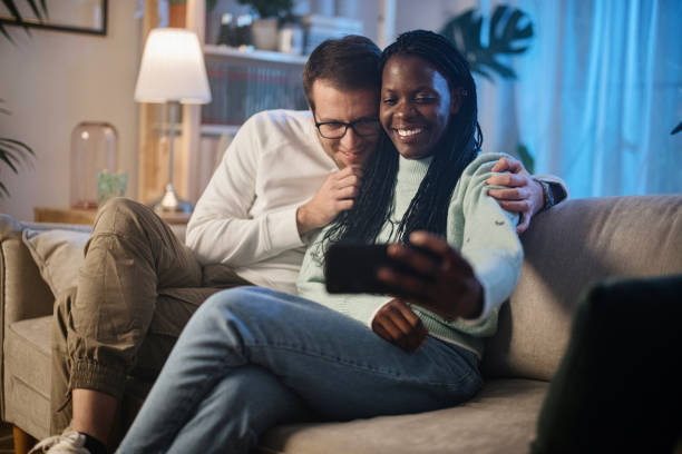 istock Couple taking selfie at home 1366672828