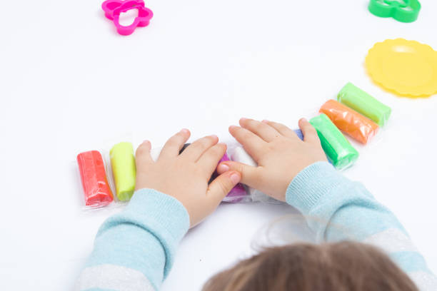 istock Childrens hands play dough for children's creativity. Board game for the development of fine motor skills 1366674814