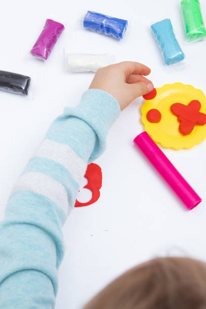 istock Childrens hands play dough for children's creativity. Board game for the development of fine motor skills 1366674892