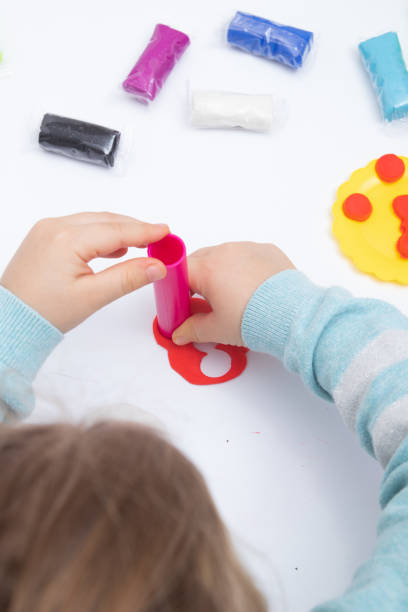istock Childrens hands play dough for children's creativity. Board game for the development of fine motor skills 1366674912