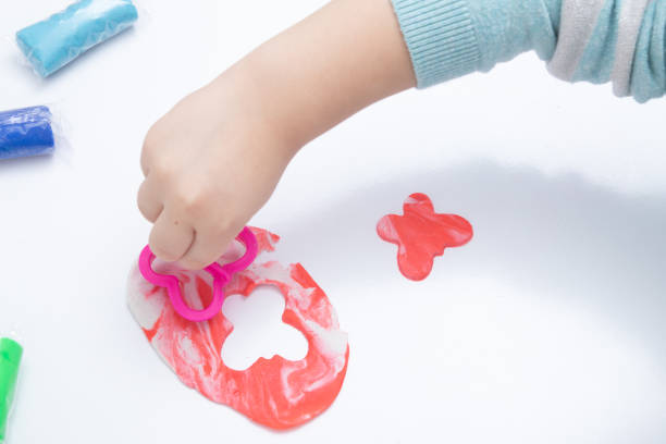istock Childrens hands play dough for children's creativity. Board game for the development of fine motor skills 1366674994