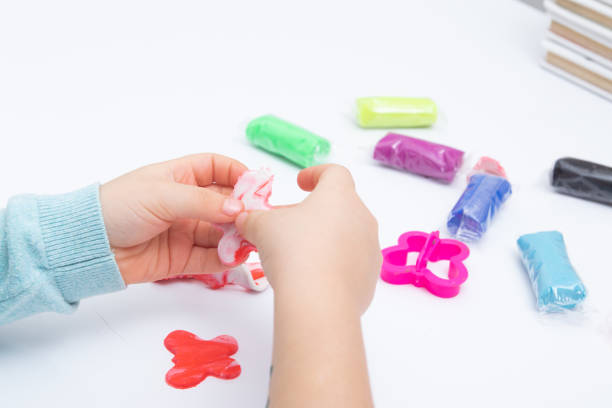 istock Childrens hands play dough for children's creativity. Board game for the development of fine motor skills 1366675001