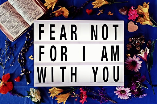 The Words 'Fear Not For I Am With You' in Lightbox Trend surrounded by Religious Alter Items for a Religious Revival Theme.