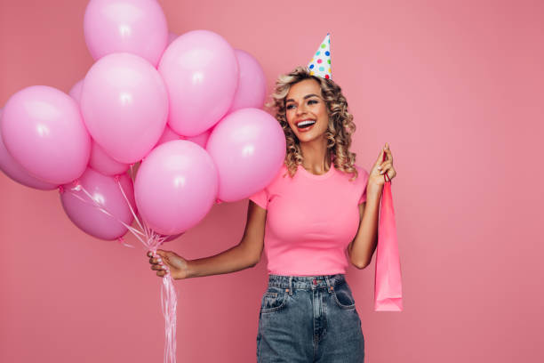 istock Happy beautiful woman with balloons 1366677024