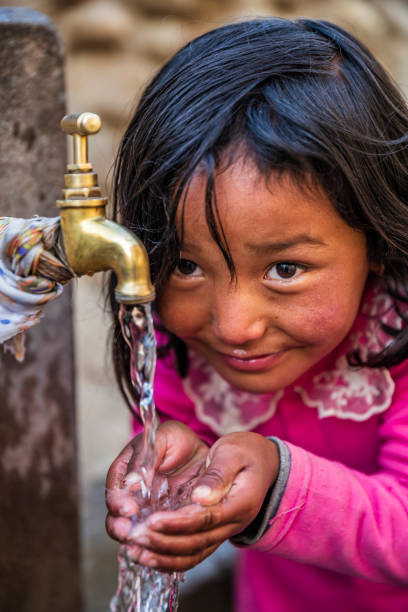 istock Nepalese girl drinking water, Upper Mustang, Nepal 1366677191