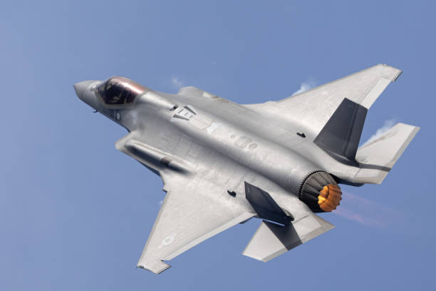 Close top view of a F-35C Lightning II  with afterburner on Close top view of a F-35C Lightning II  with afterburner on fighter plane stock pictures, royalty-free photos & images