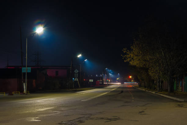Beautiful perspective view of the illuminated Bazhova Street in autumn at night, Kurgan, Russia