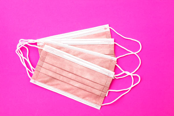 istock Protective pink face mask  on pink background 1366682548