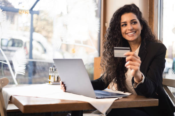 istock Woman using laptop and credit card 1366683486